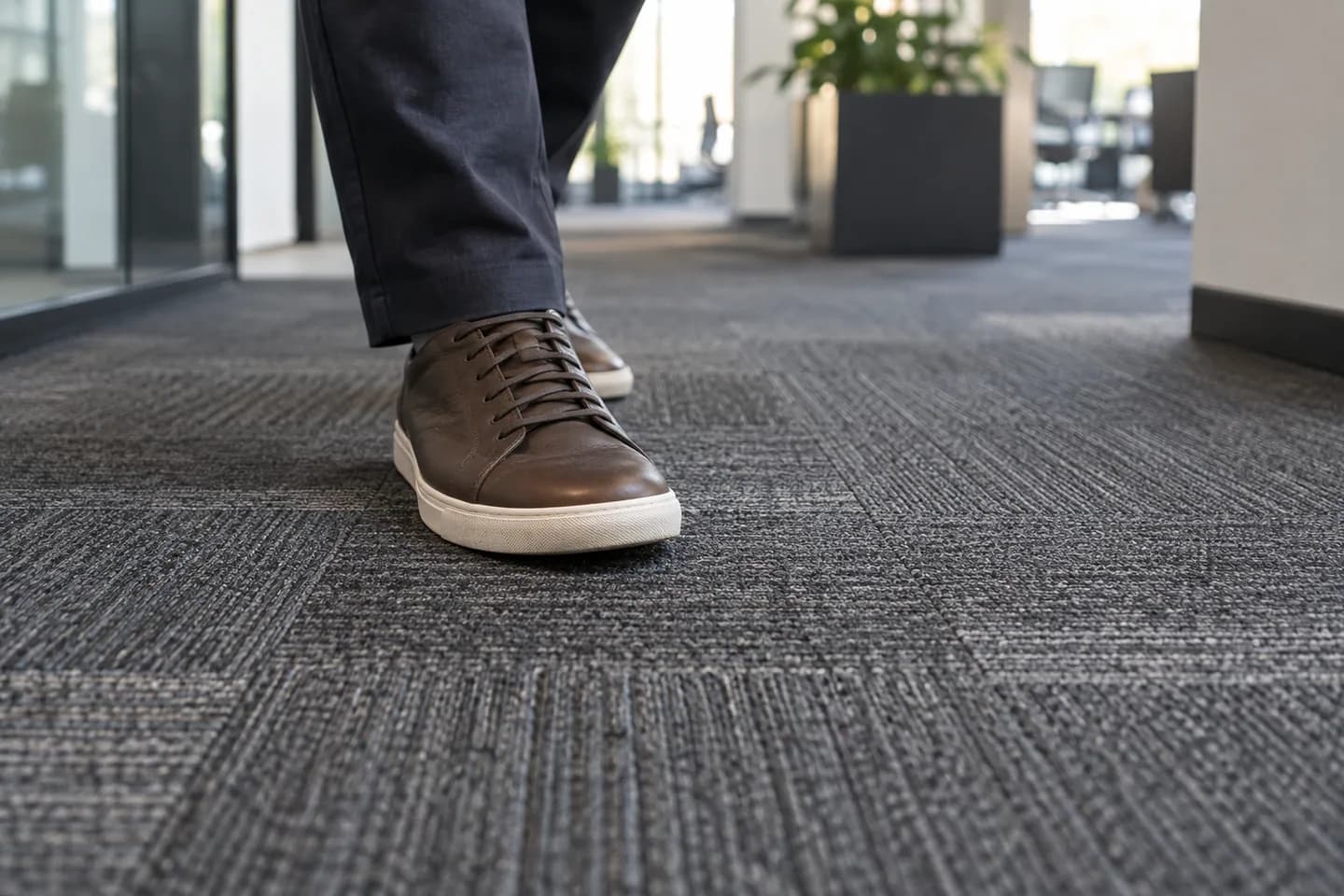 Footstep on modular carpet tile in an office corridor