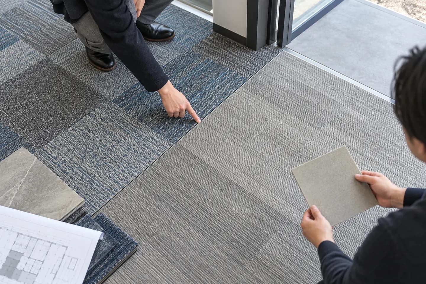 Square carpet tile and plank zones meeting at a doorway boundary