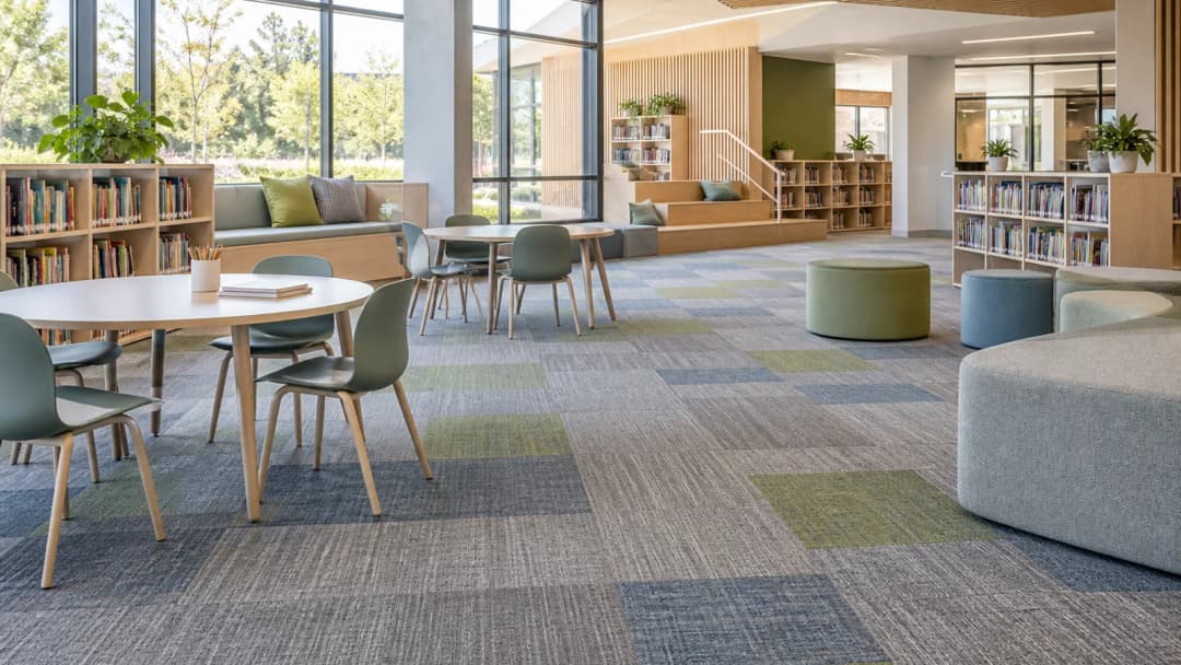 School library and shared learning area divided into subtle carpet tile zones