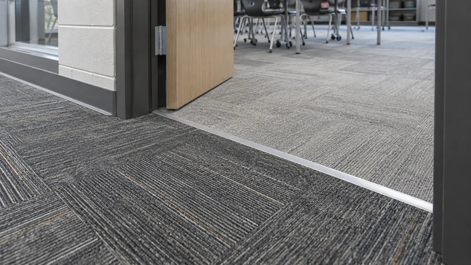 School classroom doorway showing carpet tile boundary and chair route