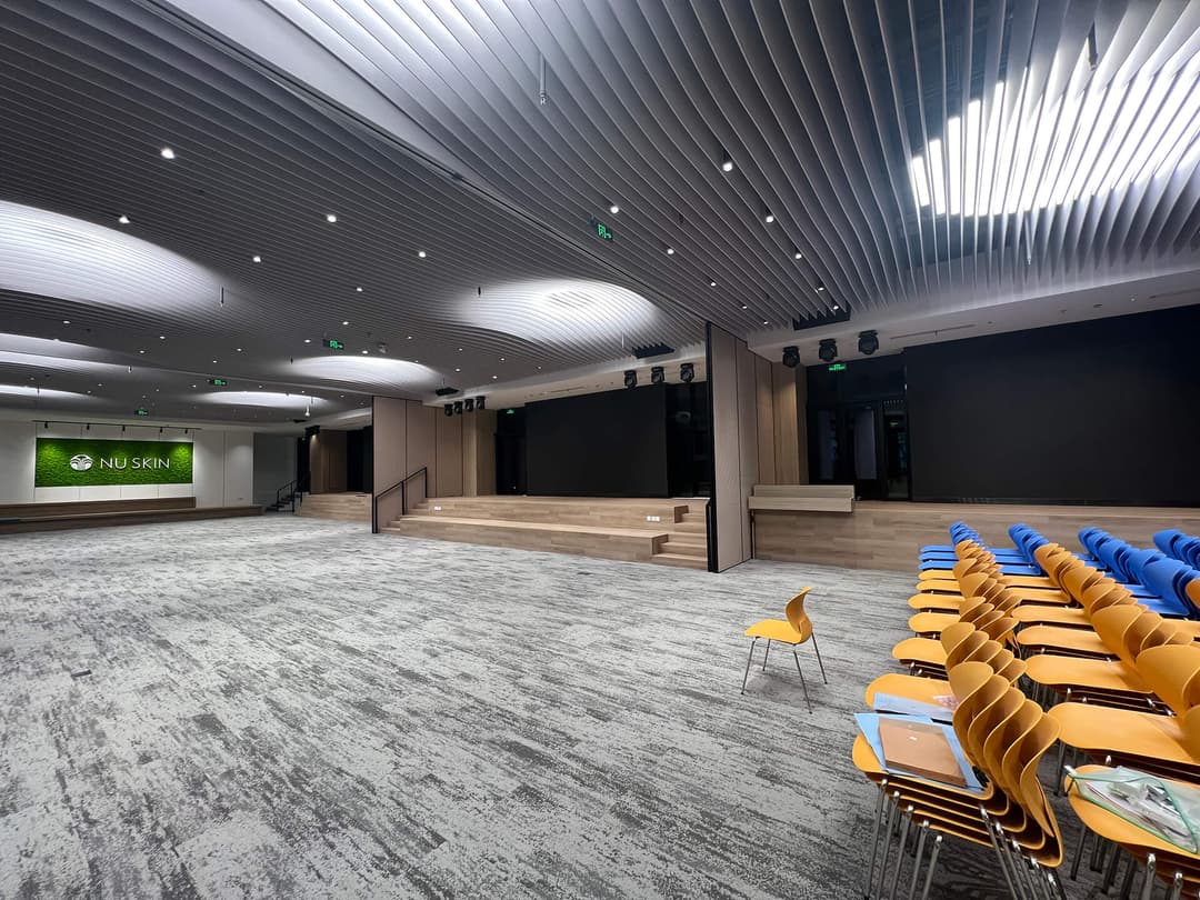 UNIJOY carpeted commercial auditorium with a patterned floor and seating, used as visual context for requesting evidence before ordering