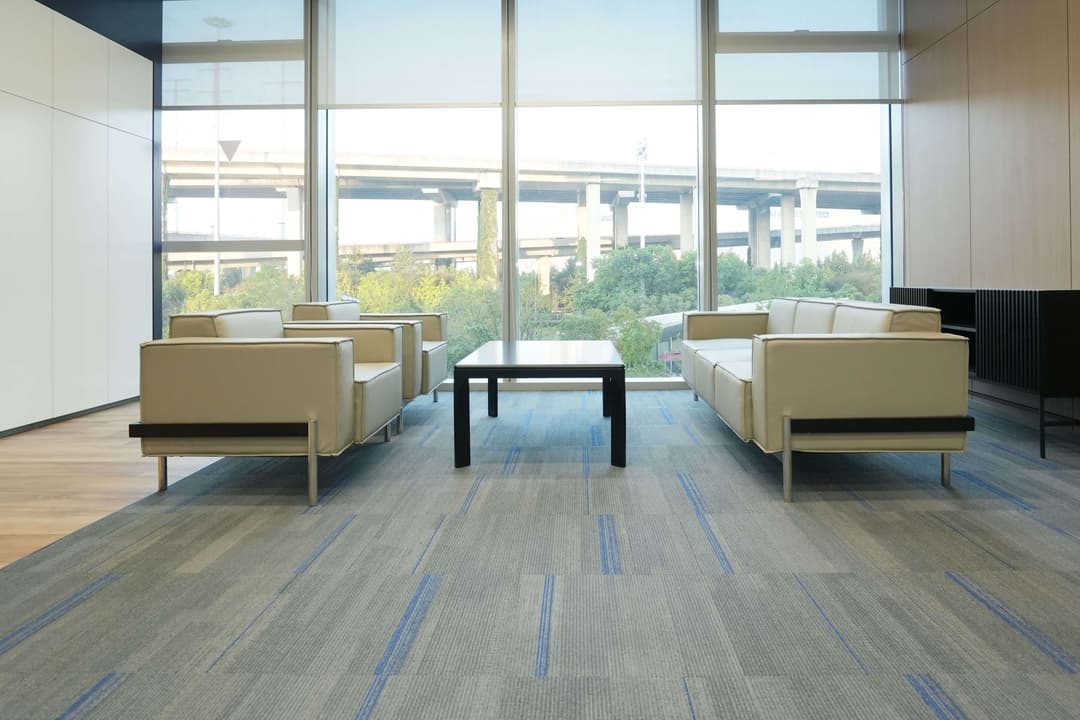 UNIJOY carpet tile visual context in a public-facing interior used for a transport-hub specification guide
