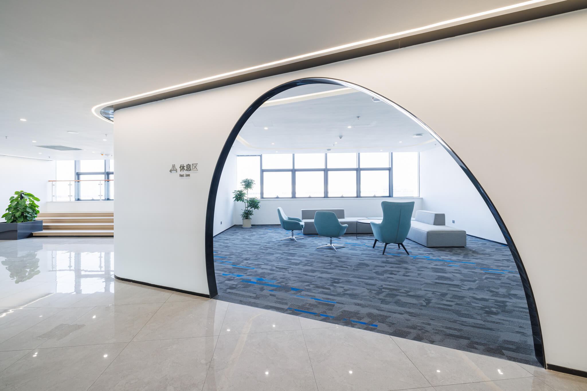 Office lounge with modular carpet tile under seating, used as visual context for reviewing conditions around a flooring brief