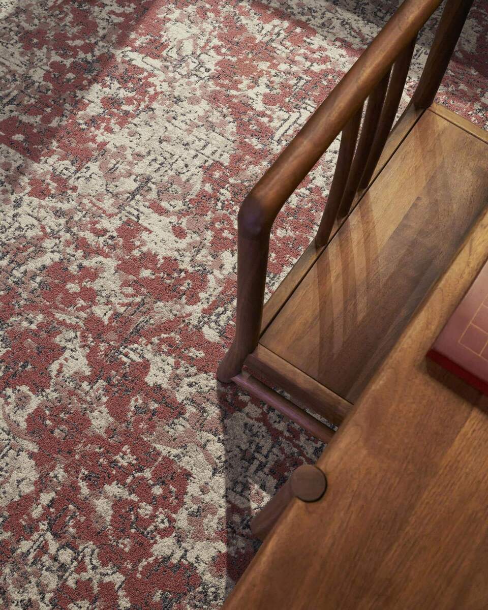 UNIJOY carpet texture beside a chair used as visual context for checking a replacement area before a decision
