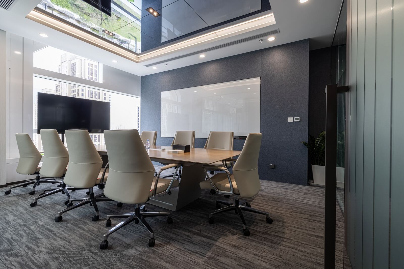 Commercial meeting room with restrained grey carpet, used as visual context for comparing floor value with furniture and walls